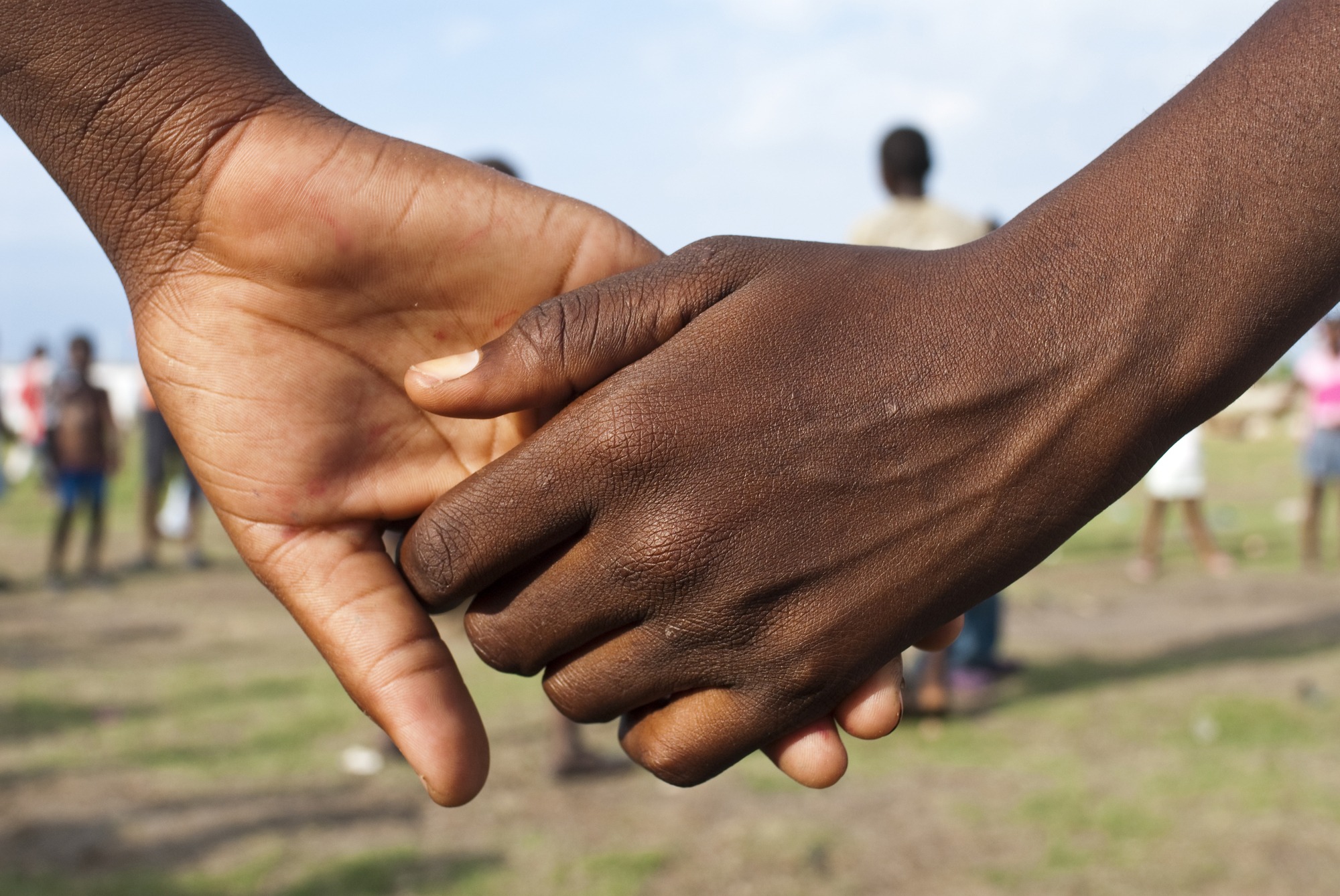 Children holding hands in Leogane